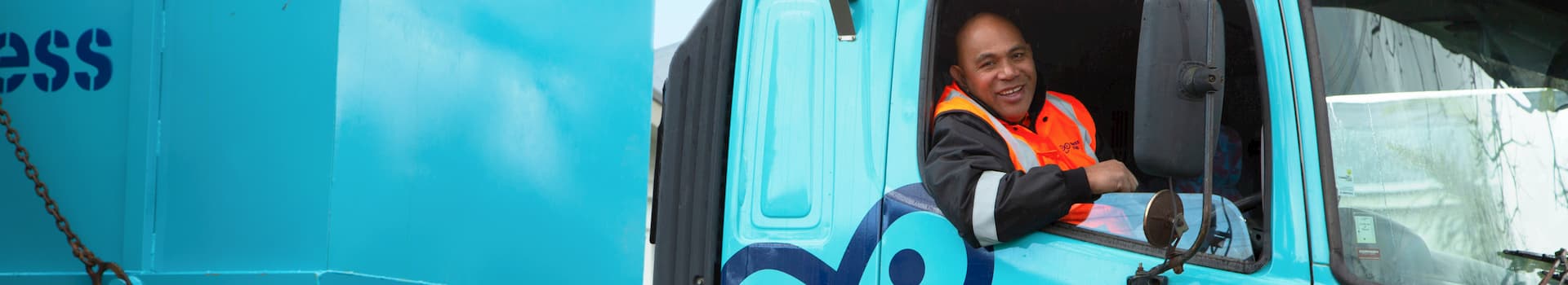 Truck driver in truck hauling cheap skip bin