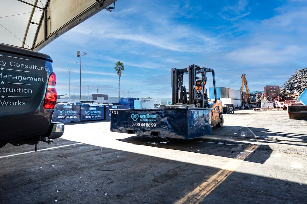 EndlessMetals_LibraryImages-90 NZ metal scrap yard with forklift carrying scrap metal bin.